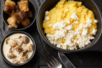 Typical Ukrainian dish polenta - Banosh with cheese and lard. Ukrainian cuisine. maize porridge...