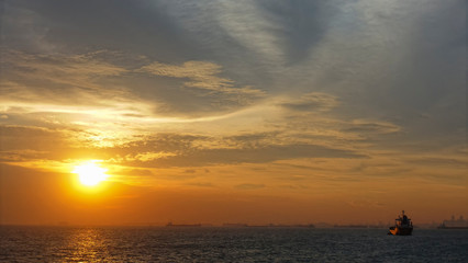 Naklejka na ściany i meble sunset over the sea at Singapore