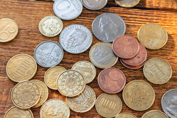 coins old and new Europe euro pile pack heap on a wooden background mock up selective focus close up