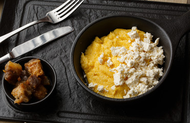 Typical Ukrainian dish polenta - Banosh with cheese and lard. Ukrainian cuisine. maize porridge...