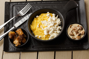 Typical Ukrainian dish polenta - Banosh with cheese and lard. Ukrainian cuisine. maize porridge...