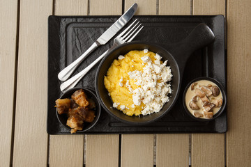 Typical Ukrainian dish polenta - Banosh with cheese and lard. Ukrainian cuisine. maize porridge...