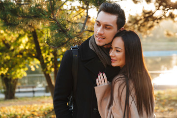 Fototapeta premium Beautiful loving couple posing walking hugging outdoors in park nature.