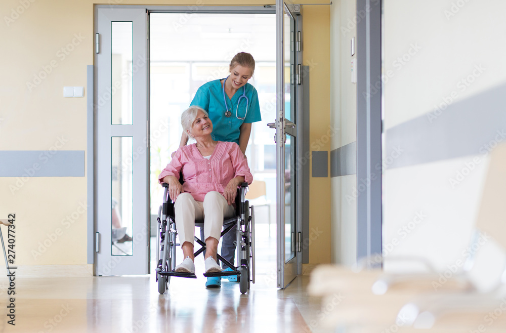 Sticker senior woman in wheelchair with nurse in hospital