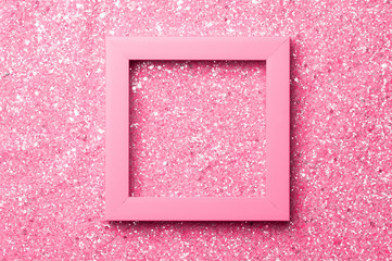 Pink frame for a photo or inscription on a shiny glitter background.