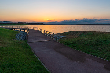 Bridge near lake at sunset