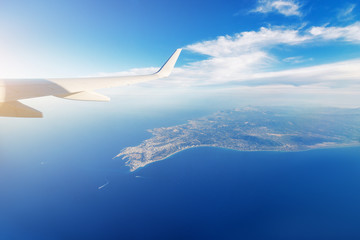 View from the airplane on a sea and the Rhodes island. Vacation and transportation concept