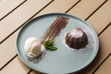 Delicious fresh fondant with hot chocolate and ice cream and mint served on plate. Lava cake...
