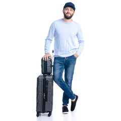 Man in jeans with travel suitcase standing on white background isolation