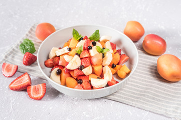 Delicious fruits salad in plate on table close-up
