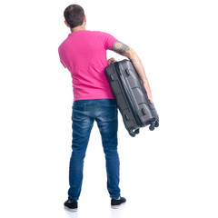 Man in jeans holding travel suitcase standing on white background isolation, back view