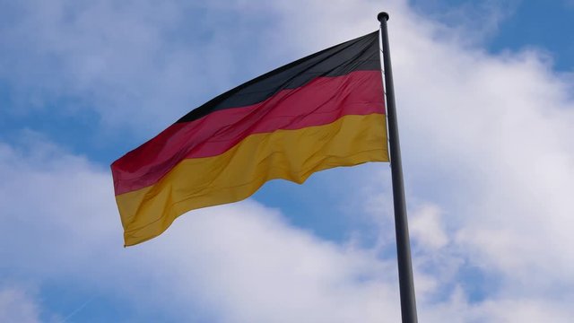 Footage of German flag on pole waving on wind.