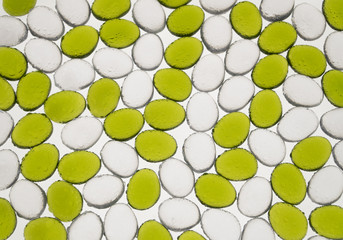 artificial round stones with water drop of green and white color, top view. imitation pebbles