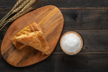 Concept of perfect breakfast in the morning. Coffee white cup and croissant for breakfast on wooden background on the table
