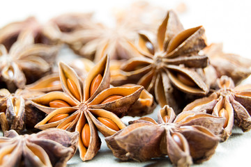 Fototapeta na wymiar Chinese Star anise spice fruits and seeds for ingredient cooking makes food fine fragrance and essential oil on a light background.