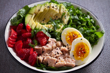 Tuna strawberry avocado egg and spinach salad in bowl - healthy food