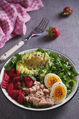Tuna strawberry avocado egg and spinach salad in bowl - healthy food