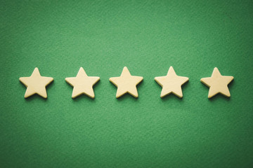 five white stars on a green background