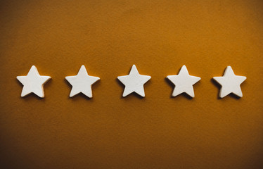 five white stars on an orange background