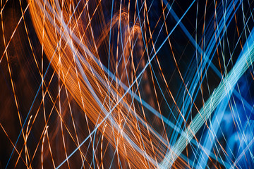 Colorful pattern of blue and orange dynamic lines of light. Modern blurred background. Art concept of lighting effects.