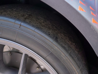 aluminum wheel rim on slick car racing tire