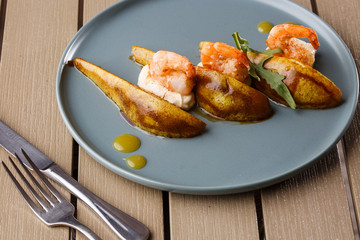 Grilled tiger shrimps with honey rear and cream cheese. Grilled seafood. On wooden background.