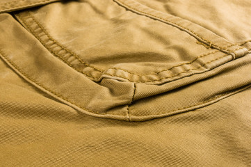 clothing items stonewashed cotton fabric texture with seams, clasps, buttons and rivets, macro