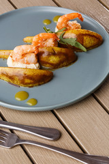 Grilled tiger shrimps with honey rear and cream cheese. Grilled seafood. On wooden background.