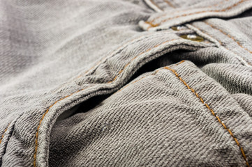 clothing items stonewashed cotton fabric texture with seams, clasps, buttons and rivets, macro