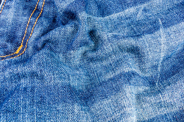 clothing items blue stonewashed faded jeans cotton fabric texture with seams, clasps, buttons and...