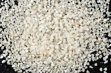 Couscous bulk on a dark background, closeup. Macro shooting.