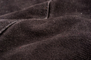 clothing items stonewashed cotton fabric texture with seams, clasps, buttons and rivets, macro