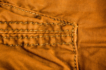 clothing items stonewashed cotton fabric texture with seams, clasps, buttons and rivets, macro