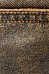 clothing items stonewashed cotton fabric texture with seams, clasps, buttons and rivets, macro