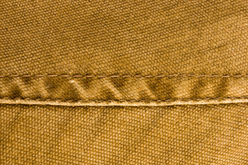 clothing items stonewashed cotton fabric texture with seams, clasps, buttons and rivets, macro