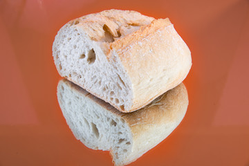 Close-up of a delicious and fresh slice of baguette, on a mirror