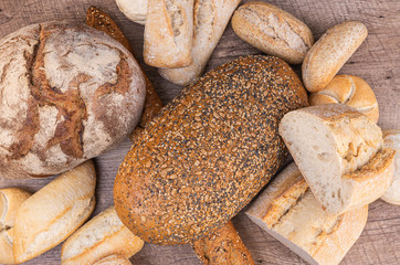 Delicious freshly baked bread on rustic wooden table. Top view