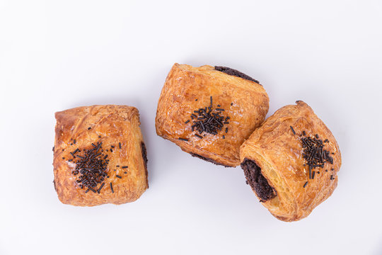 Top view of three tasty puff pastry rolls filled with freshly baked chocolate