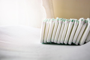 Group of disposable diapers arranged over a white changing table