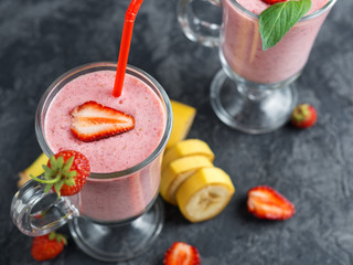 Strawberry smoothie or milkshake in a glass on the table. Healthy and delicious Breakfast