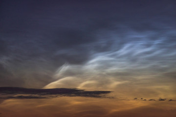 Noctilucent clouds closeup summer night.