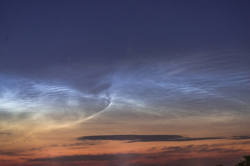 Noctilucent clouds closeup summer night.