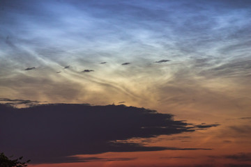 Fototapeta na wymiar Noctilucent clouds closeup summer night.