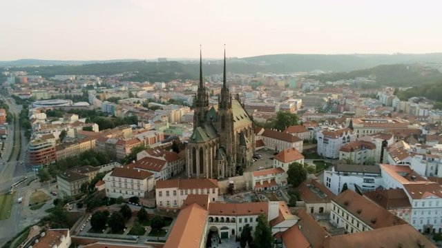 Europe, Czech Republic, Brno Cityscape with Landmarks, Cathedral of St. Peter And St. Paul. Aerial View of Old Town with Medieval Gothic Church on Petrov Hill at Sunset. 4K Zoom Quadcopter Shot