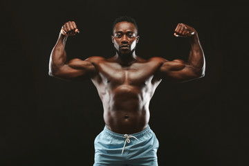 Fototapeta na wymiar African athlete showing muscular hands and shoulders