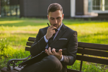 Worried businessman working outdoor.Toned photo.