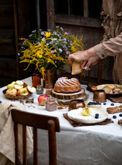 beautiful outdoor still life in country garden with bundt cake on wooden stand on rustic table