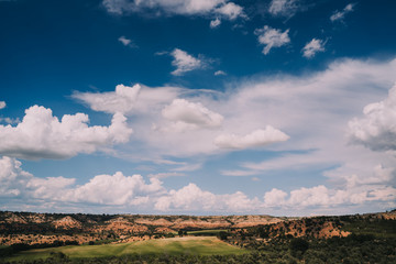 Fototapeta premium Landscape of nature. Rural area in Spain. Beautiful meadows with mountains and a beautiful blue sky with clouds. Panoramic background.
