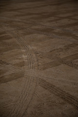 Car wheels marks on sand