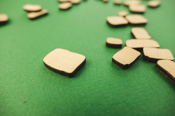 a pile of wooden stones and one big building on a green background
